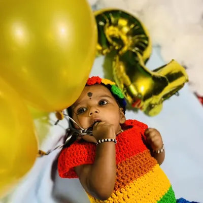 A beautiful client photo featuring my rainbow frock and matching headband. The bright, cheerful colors make this a wonderful outfit for birthday photoshoots or any happy celebration.