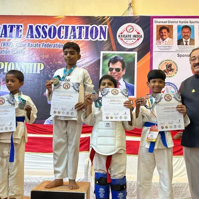Our students proudly display their medals and certificates on the podium at the State Level Championship in Hubli. This is the reward for their dedication to both kata and kumite.