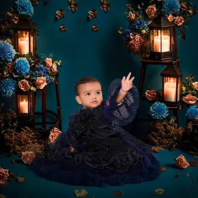 This elegant, dark-themed setup is a great example of the unique concepts I can create in my studio. The combination of deep blues, warm candlelight, and a beautiful gown makes for a stunning portrait.