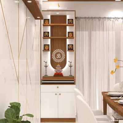 This elegant pooja unit is designed to fit seamlessly into a modern living or dining area. The backlit panel highlights the 'Om' mandala and provides a divine glow for the idols.