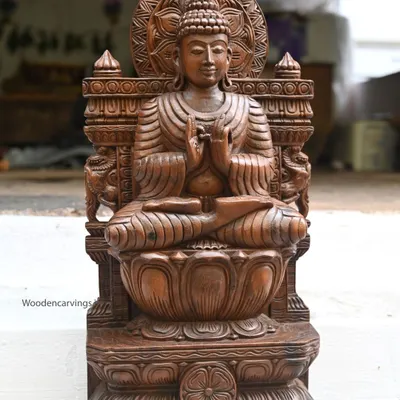 A 24-inch Lord Buddha statue, handcrafted with a wax brown finish. Depicted in the Dharmachakra mudra for teaching, this sculpture is perfect for creating a space of peace and learning in your home.