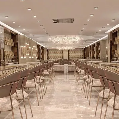 An expansive view of a luxury gold jewellery showroom we redesigned. The long, symmetrical layout, combined with consistent lighting and elegant seating, creates a grand and immersive customer journey from the moment they enter.