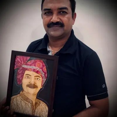 A happy client holding his custom framed henna portrait. These make for incredibly personal and unique gifts, capturing a loved one in the timeless art of henna.