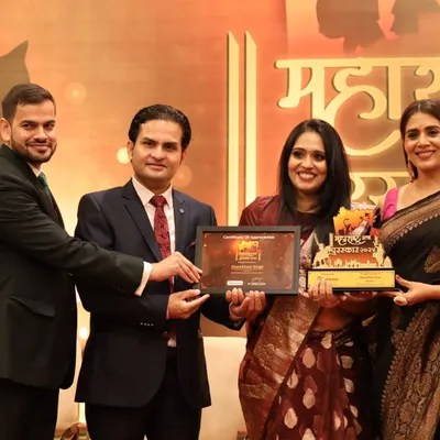 Receiving the Maharashtra Ratan Puraskar award on stage. This state-level recognition in my home of Mumbai is a deeply meaningful milestone in my 26-year journey as a healer and life coach.