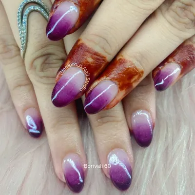 A stunning purple ombre. This design features a beautiful, seamless gradient from a deep, rich purple to a shimmery, pearlescent white, creating a look that is both bold and elegant.