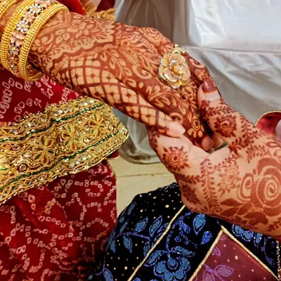 This is what I call stain goals. The deep, rich color of the henna is beautifully captured in this photo, showing the intricate patterns holding hands.