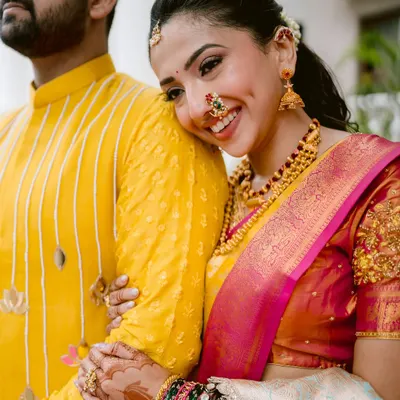 Maithili's radiant smile says it all. This close-up from her engagement in Satara highlights the intricate beauty of her traditional Maharashtrian jewelry and the sheer happiness of the moment.