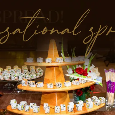 An impressive multi-tiered wooden stand displaying a wide variety of sushi rolls. Our sushi stations are a popular choice for adding a touch of international sophistication to any event.