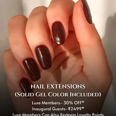 A classic and bold look featuring long, sculpted nail extensions with a solid, deep maroon gel color. This image showcases a flawless application and a rich, glossy finish.