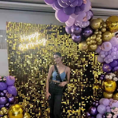 A stunning golden sequin wall we set up for a client's birthday. Framed by a rich purple and gold balloon arrangement and a custom neon sign, this backdrop is designed to make a statement.