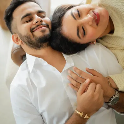 A moment of complete peace and togetherness. This overhead shot from a cozy indoor pre-wedding session captures the feeling of finding rest and comfort in each other's arms.