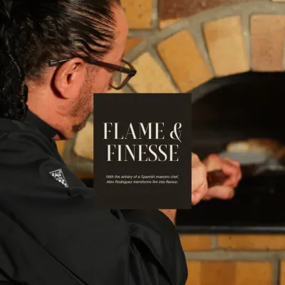 This image, titled "Flame & Finesse," captures me at the wood-fired oven. The fire is an essential tool in my kitchen, bringing rustic flavour and tradition to our dishes.
