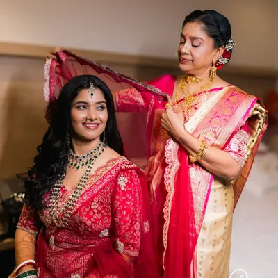 A mother's gentle touch as she helps her daughter with her veil. These moments between family are priceless.