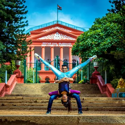 Can't get enough air-time! This acrobatic lift, framed by the iconic High Court of Karnataka, shows the kind of dynamic and athletic moves we can incorporate into a performance.