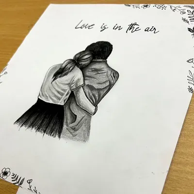A detailed pencil drawing of a couple sharing an embrace, framed by a delicate floral border. This romantic sketch is a beautiful way to capture love and makes for a personal anniversary or wedding gift.