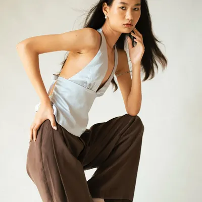 A dynamic pose against a clean studio background, perfect for a model's portfolio to show movement and form.