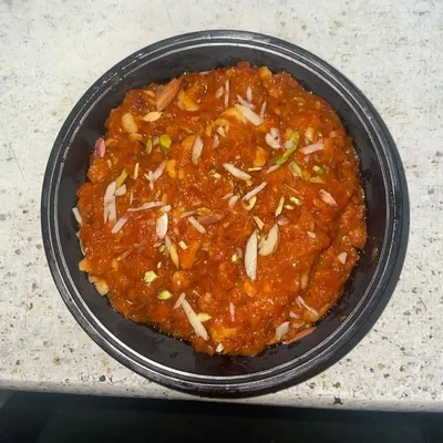 To satisfy your sweet tooth, I prepare traditional Gajar ka Halwa. It's slow-cooked to perfection and garnished with slivered almonds and pistachios for a rich, homemade dessert experience.
