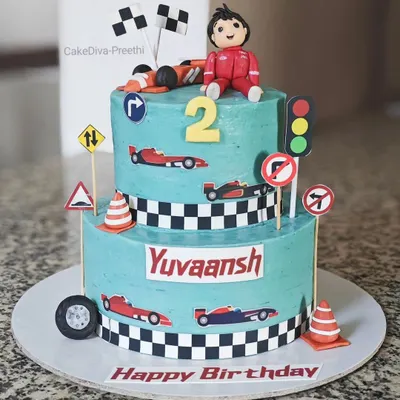 Growing up "two" fast, too curious! This two-tier red velvet ganache cake was for a race car-themed second birthday, complete with fondant cars, traffic signs, and a checkered flag pattern.