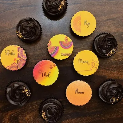 Getting into the Diwali spirit with this custom cupcake box for a squad. The set includes chocolate cupcakes with dark chocolate frosting and personalized toppers with names and vibrant mandala and diya designs.