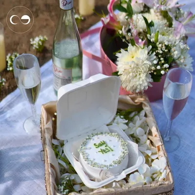 Crafting the perfect beachside proposal starts with personal touches. A custom "Say Yes" cake, chilled champagne, and a beautiful floral arrangement create a simple yet unforgettable setting for a magical question.