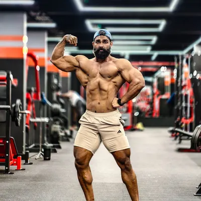 A classic physique pose showcasing overall symmetry, muscle mass, and conditioning. This is the standard I work towards, balancing size with aesthetics. I help coaches understand how to build a complete and balanced physique.