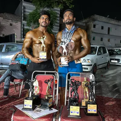 Two of my students with their hard-earned trophies. Their condition and posing reflect countless hours of dedicated work in the gym and kitchen.