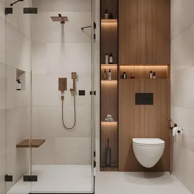 This modern bathroom uses a wall-mounted toilet and a glass shower partition to create a sense of spaciousness. The tall wooden panel cleverly conceals plumbing while providing beautifully lit niches for storage, combining aesthetics with practicality.