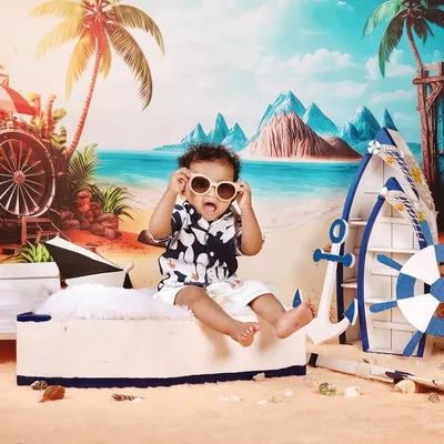 Fun and creative themed photoshoots are one of my specialties. For this pre-birthday session, we created a vibrant beach scene right in the studio, complete with a boat, sand, and sunglasses for little Naksha to enjoy. These shoots are all about capturing your child's personality.