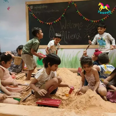 The sandpit is buzzing with activity! It's the perfect place for kids to engage in imaginative group play, building castles and creating stories together.
