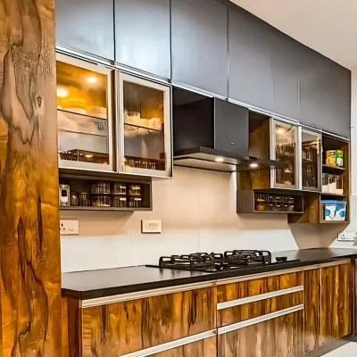 This kitchen showcases the beauty of a rich, dark wood grain on the cabinets. Paired with matte black uppers and glass-fronted display sections, the look is both rustic and modern.