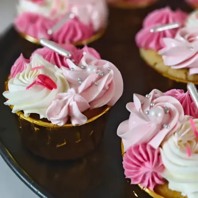 A beautiful batch of my vanilla cupcakes with strawberry buttercream frosting. I love how the pink and white swirls look together, making them almost too pretty to eat.