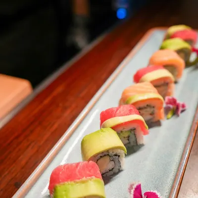 Our Rainbow Roll is a vibrant masterpiece, wrapped in alternating layers of fresh tuna, salmon, and creamy avocado. It is a celebration of flavor and artistry, crafted with precision and the finest ingredients.