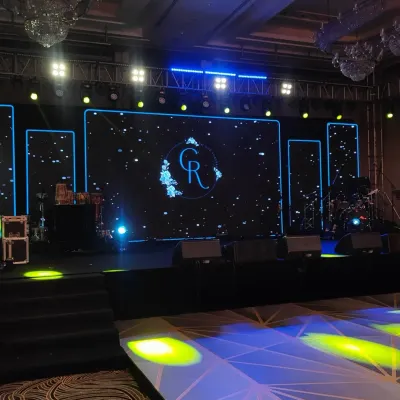 I designed this sangeet stage for a full-on concert experience. A massive LED screen displays custom graphics, flanked by professional lighting rigs and a stage ready for live performances, ensuring a night of high energy.