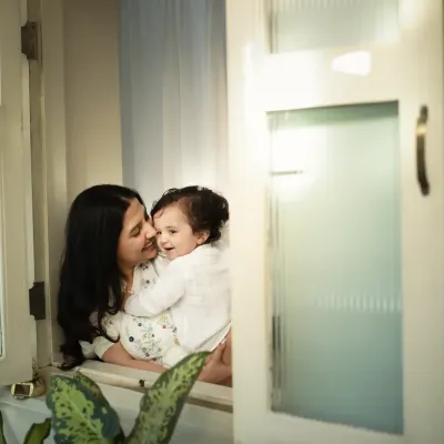 The pure love between a mother and her child. This candid moment by the window, filled with soft light and gentle smiles, is what I call a perfect memory.