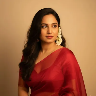 A beautiful, soft, and elegant look I created. The client is wearing a simple red organza saree with jasmine flowers in her hair, a timeless and classic style.