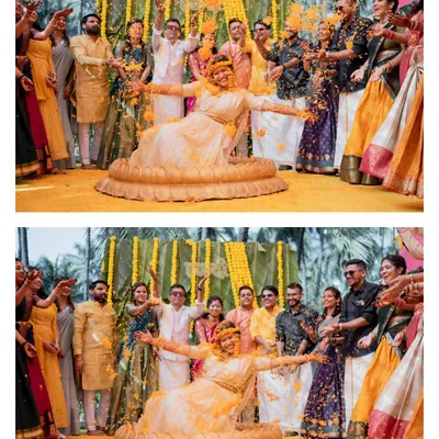 The quintessential Haldi moment. The bride is showered with marigold petals by her family and friends in a joyous celebration.