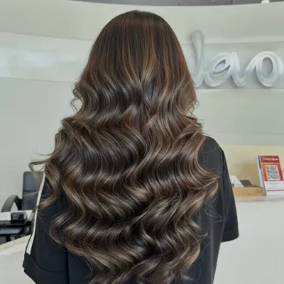 This is my mushroom brown magic. It's the perfect balance of cool ash and natural brown tones, creating a sophisticated color with lots of depth and styled here with soft waves.