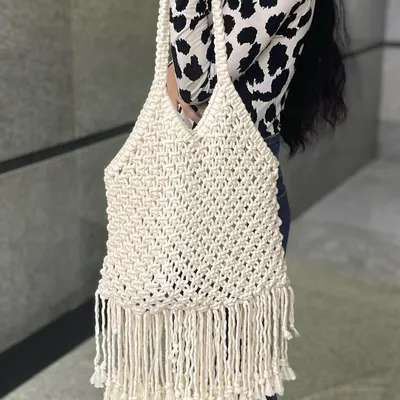 This is my large macrame tote bag in a classic off-white color. It's incredibly spacious and has beautiful fringe detailing at the bottom for that boho touch.