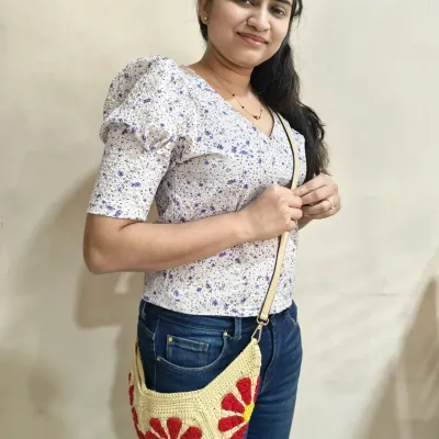 Here I am modeling the finished Groovy Daisy crossbody bag. It’s a joy to wear something you’ve made with your own hands. This project is a fantastic way to learn how to join granny squares to create a three-dimensional object.