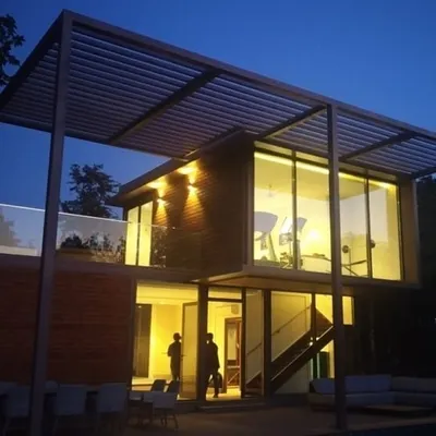 The villa at night reveals a warm, inviting glow, highlighting the open-plan living spaces. This is a testament to our philosophy of creating beautiful, functional homes through modern prefab architecture.