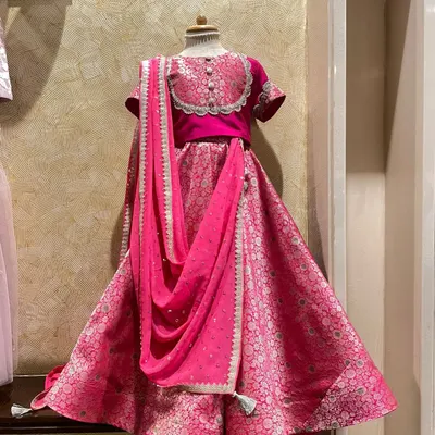 This vibrant pink lehenga was handcrafted for a 6-year-old girl from a fabric her mother treasured. I focus on creating comfortable yet stunning ethnic wear, with details like the delicate neckline and matching dupatta making it perfect for any celebration.