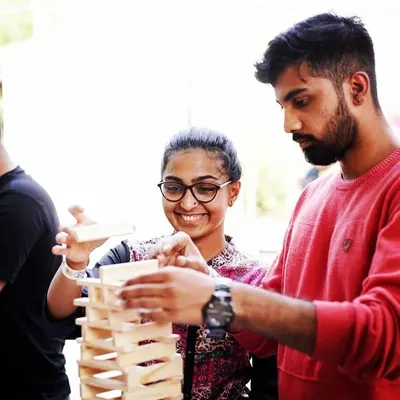 A smile of success during a collaborative build. This moment captures the essence of our workshops, where problem-solving becomes a fun, shared experience. This is creative team bonding in its purest form.