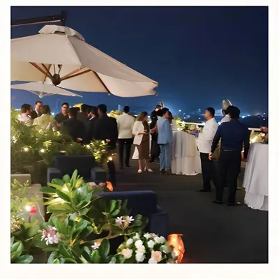 A beautiful night view of a rooftop party we catered, with guests enjoying the city lights. We excel at creating sophisticated atmospheres for evening corporate events.