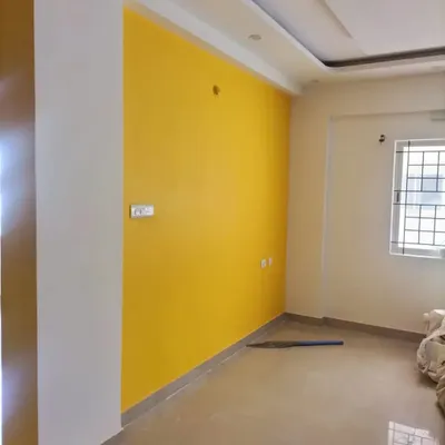 A bright and cheerful yellow accent wall in a newly painted room. A single, bold color can completely change the mood and energy of a space.