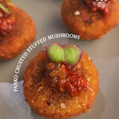 This panko-crusted stuffed mushroom offers a delightful contrast in textures. The crispy golden exterior gives way to a savoury, earthy mushroom filling, all balanced by a touch of sweet and spicy relish on top.