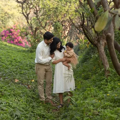 A family stroll through a lush garden path. Outdoor sessions have a wonderful, relaxed feel, and the natural environment always brings a sense of warmth and connection to the photographs.