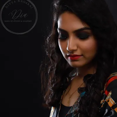 A beautiful profile shot showcasing a classic smoky eye paired with a vibrant red lip. This timeless combination is perfect for evening events and a fundamental style I teach all my students.