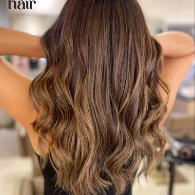 This is our signature serotonin boost in a hair colour. A beautiful brown balayage with honey tones that create warmth and dimension, styled into soft, flowing waves.