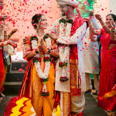 The moment the Antarpat is lowered, and they see each other as bride and groom for the first time, showered in akshata and blessings. A pinnacle moment of a Maharashtrian wedding.