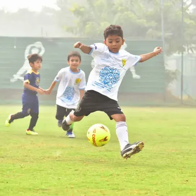 A player takes a powerful shot on goal during the Premium Autoz Football Delhi Golden Baby League.